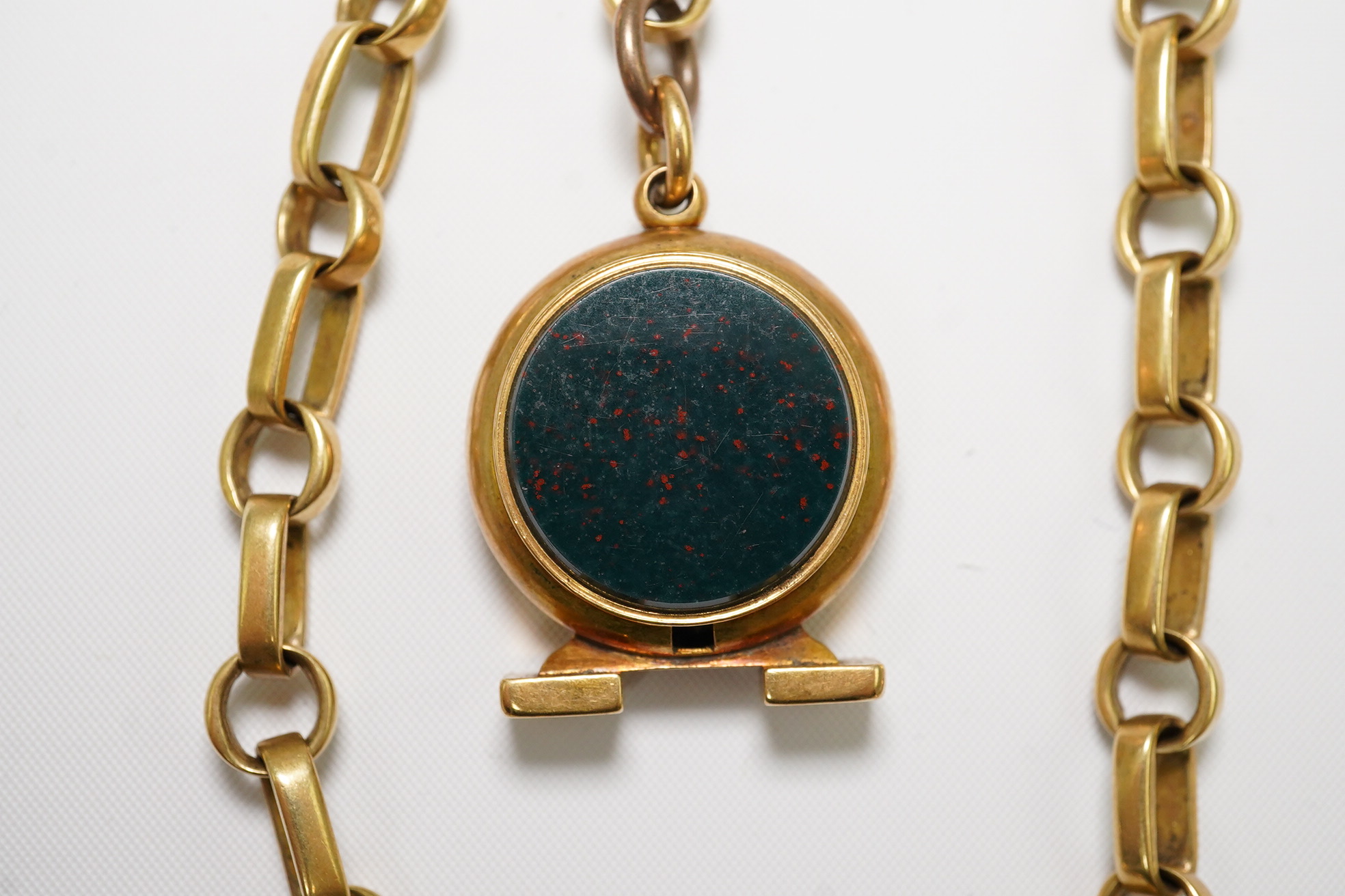 A gold oval link albert, hung with an 18ct and bloodstone set compass fob